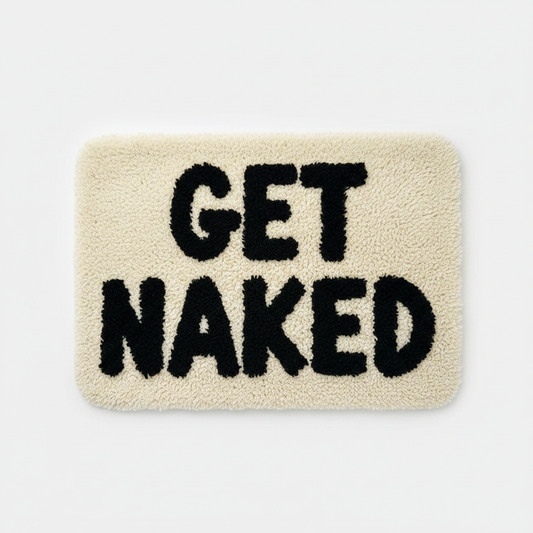 Cream fluffy plush bath mat with GET NAKED tufted lettering