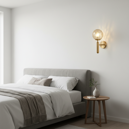 Bauer brass wall light mounted beside a bed in a modern bedroom
