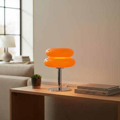 Luminara orange retro glass table lamp lit on a living-room console - lifestyle