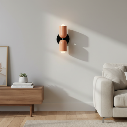 Piccadilly pink twin-tube metal wall sconce mounted in a modern living room lifestyle