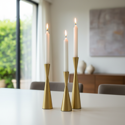 Nordic Brass Waist Candlestick Set of 3 styled with lit candles in a modern dining room