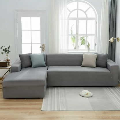 Spotted light grey L-shaped sofa slipcover styled in a modern living room