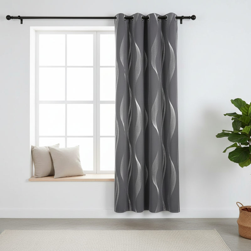 Slate Wave blackout grommet curtain hung beside a window in a styled room