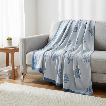 Bamboo fiber rose cooling blanket draped over a sofa in a modern room