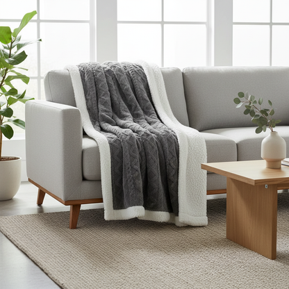 Reversible Sherpa Throw Blanket draped on a sofa